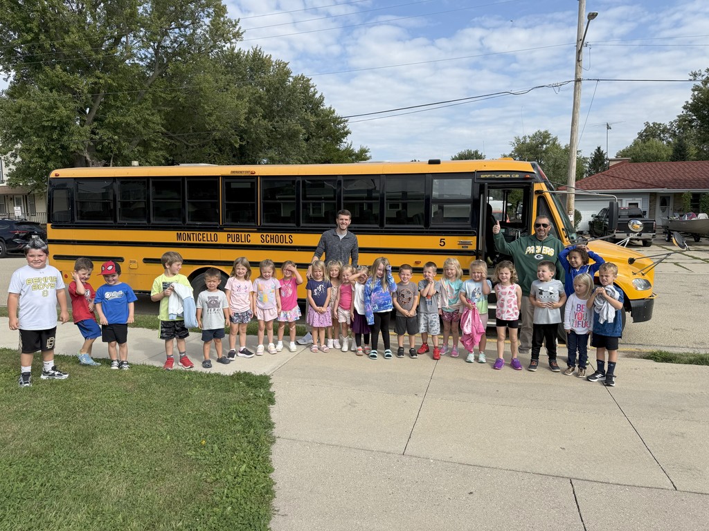 Students with Principal and Superintendent and Bus