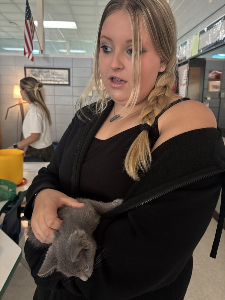 student holding kitten