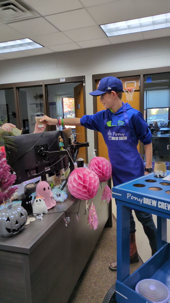 Pony Brew Crew Member Serving Coffee to a Customer