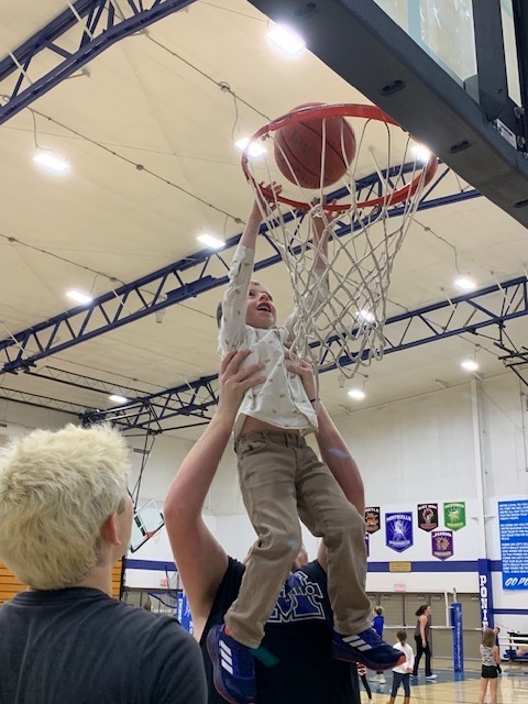 Student Shooting Basket at Play with the Ponies