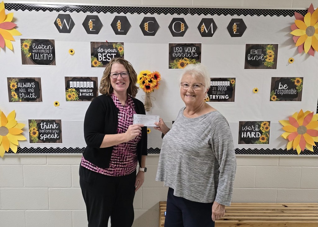 Teacher Receiving a Donation from Monticello Community Club Member
