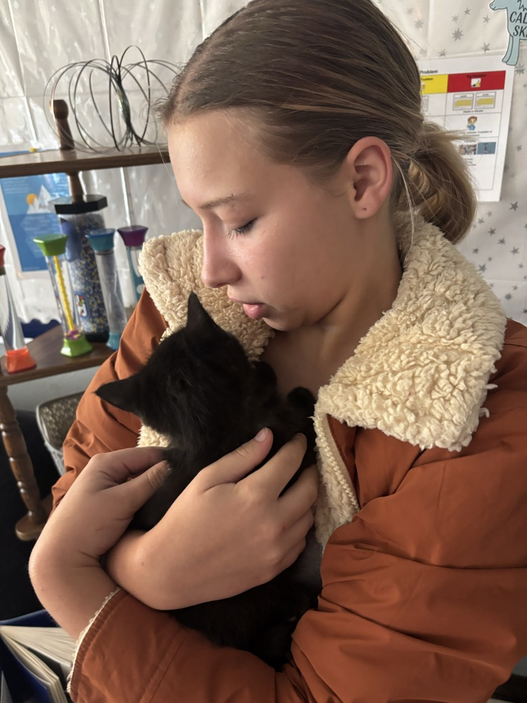 student with kitten