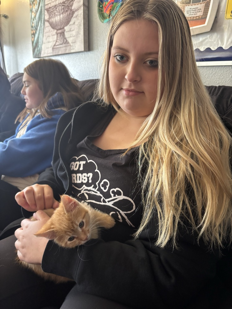 student with kitten