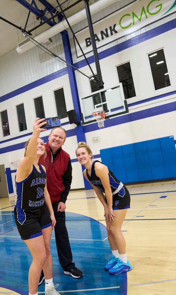 Coach and Girls Basketball Players