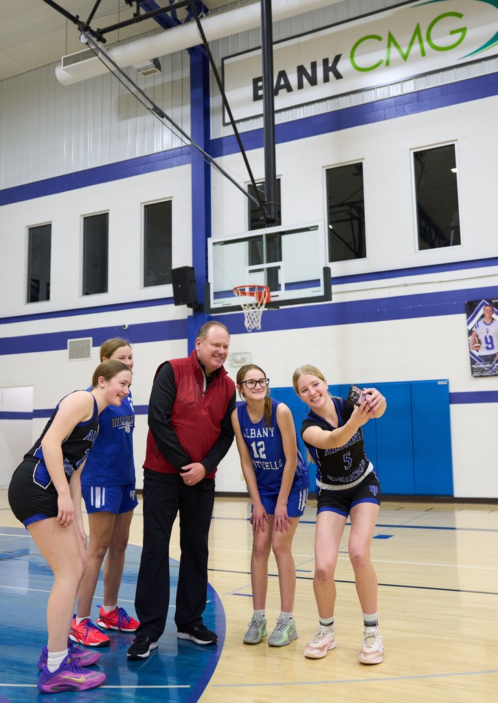 Coach and Girls Basketball Players