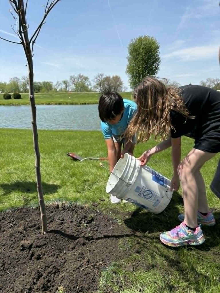 students watering tree
