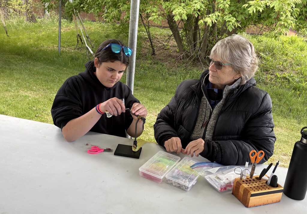 student and adult making fishing lure