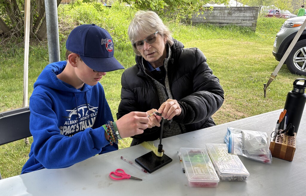 student and adult making fishing lure