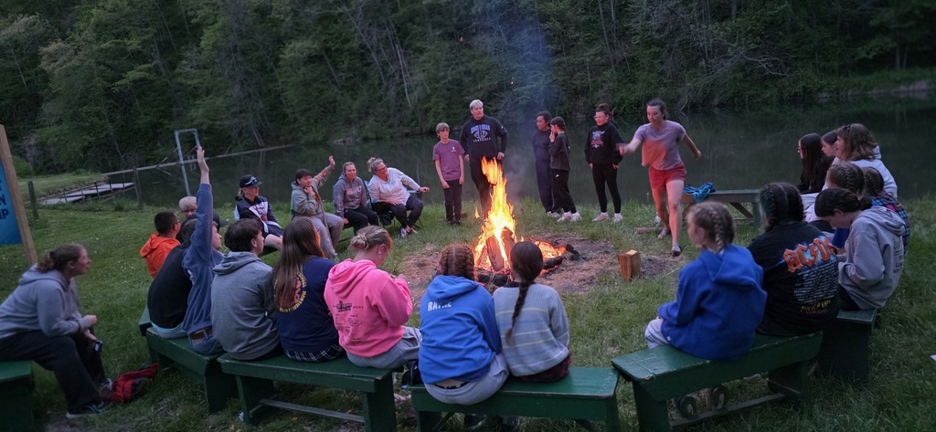 campers and counselors around campfire
