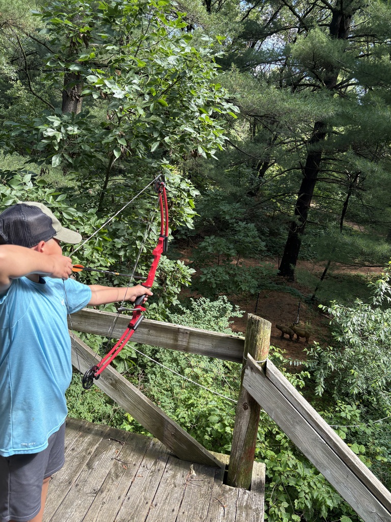 student shooting a bow
