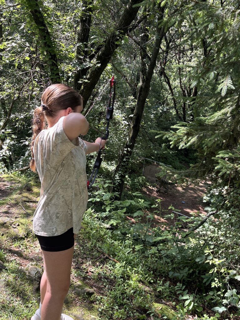 student shooting a bow