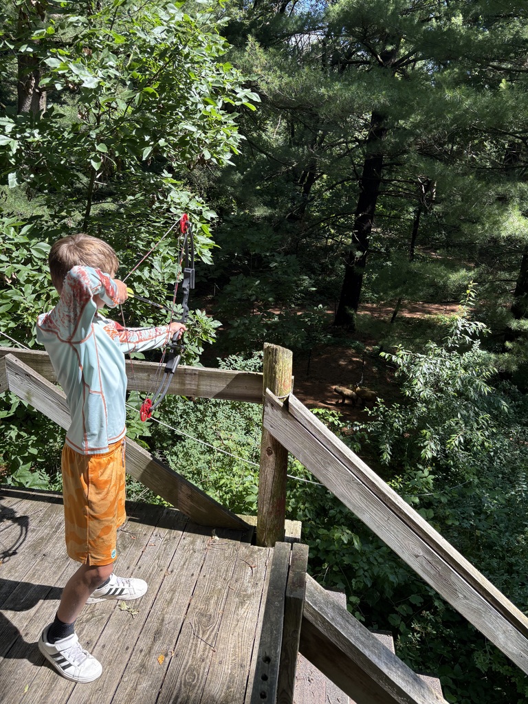 student shooting a bow
