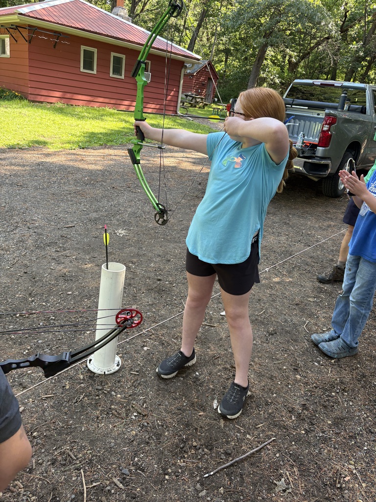 student shooting a bow