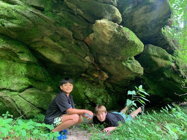 Two middle school students under a rock at Governor Dodge State Park