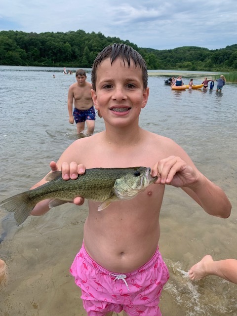 One middle school student holding a fish at Governor Dodge State Park