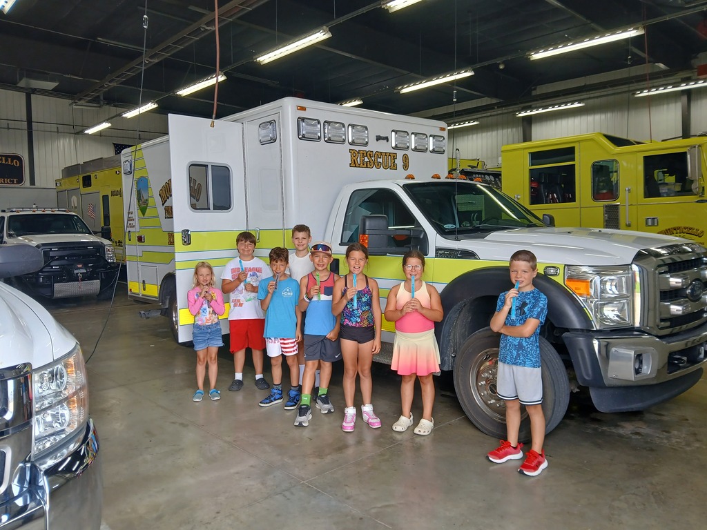 elementary students in front of a fire rescue truck