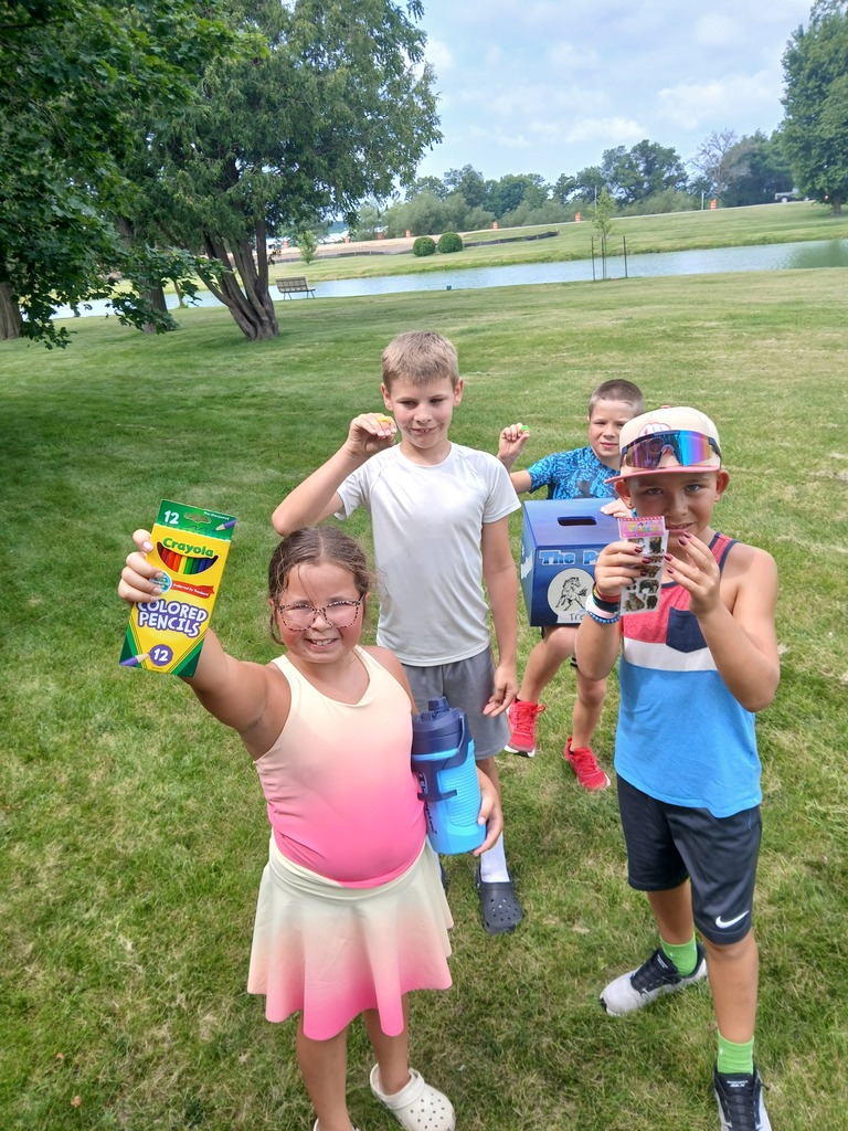 four elementary students at the lake