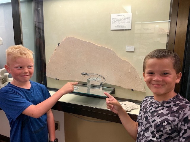 two students with artifact at University of Wisconsin -Madison's Geology museum