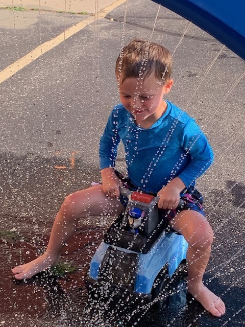 elementary student in sprinkler