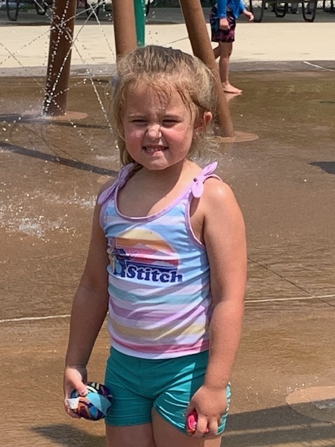 elementary student smiling at splash pad
