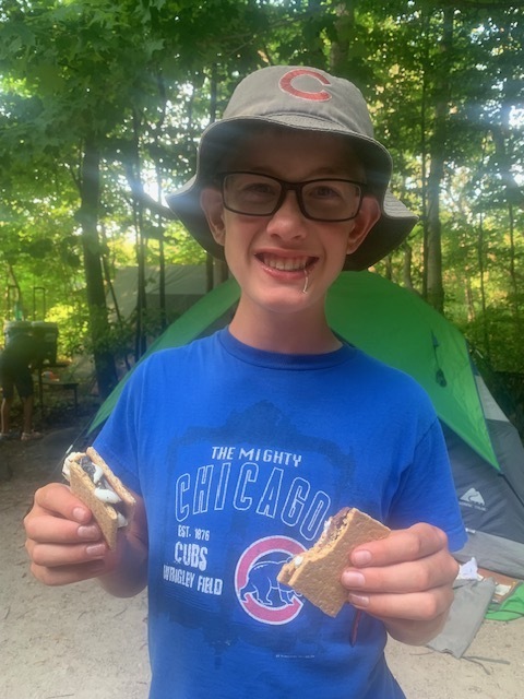 smling student with 2 s'mores