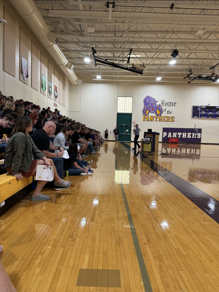 teachers and staff on bleachers in gym