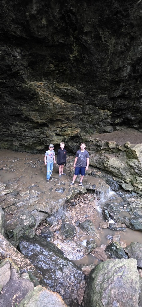 three students by a mini waterfall