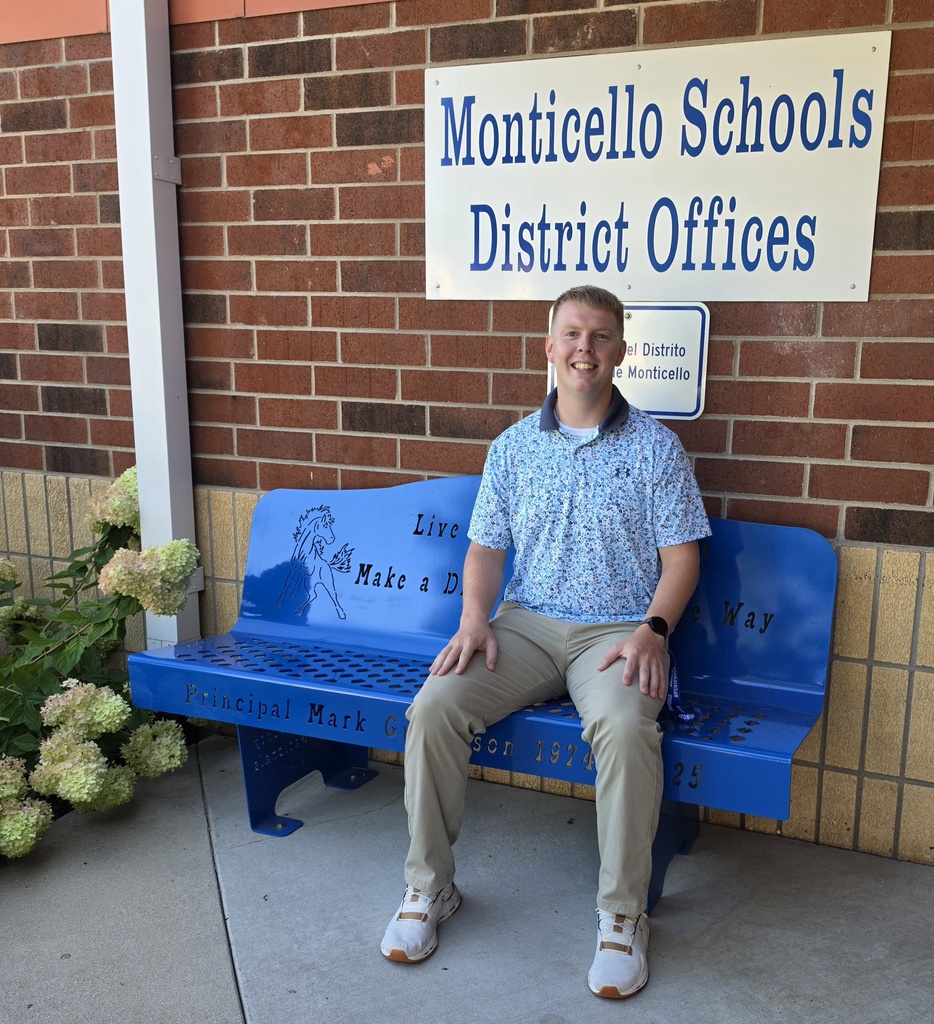 teacher on blue bench smiling