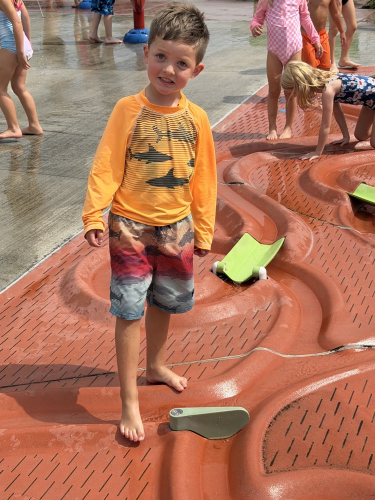 student at splash pad