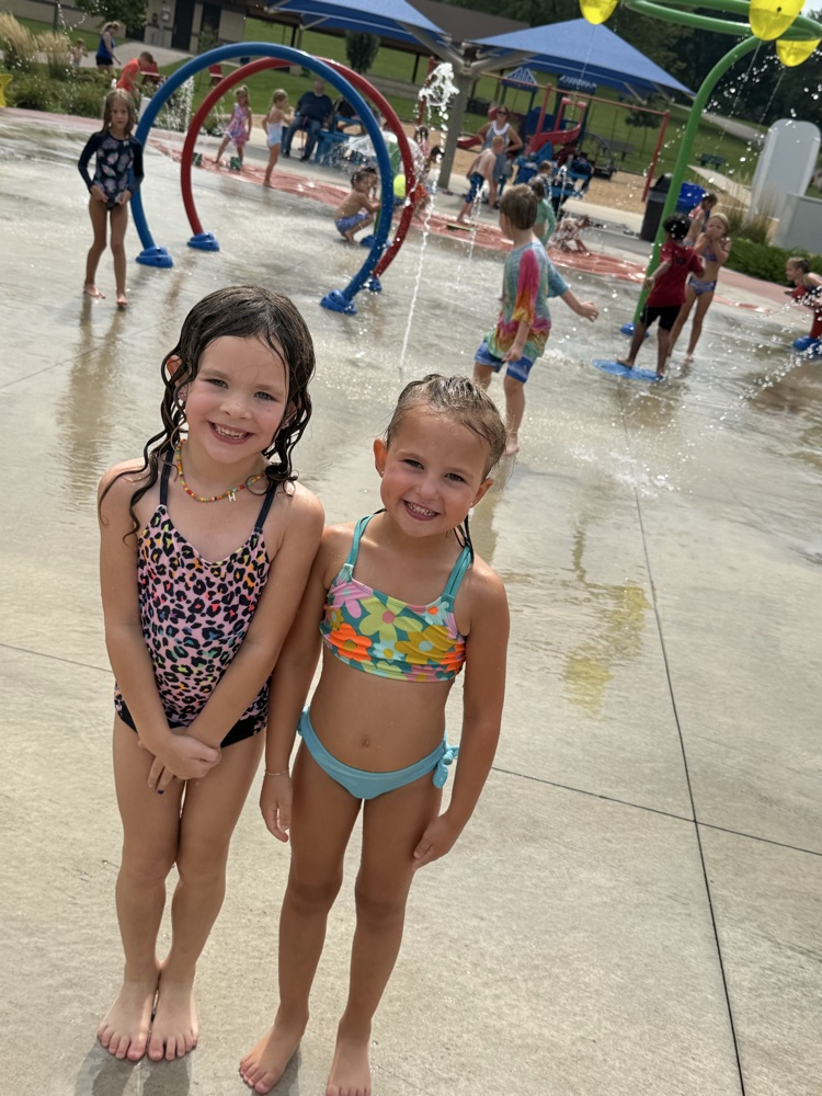 two students smiling at splash pad