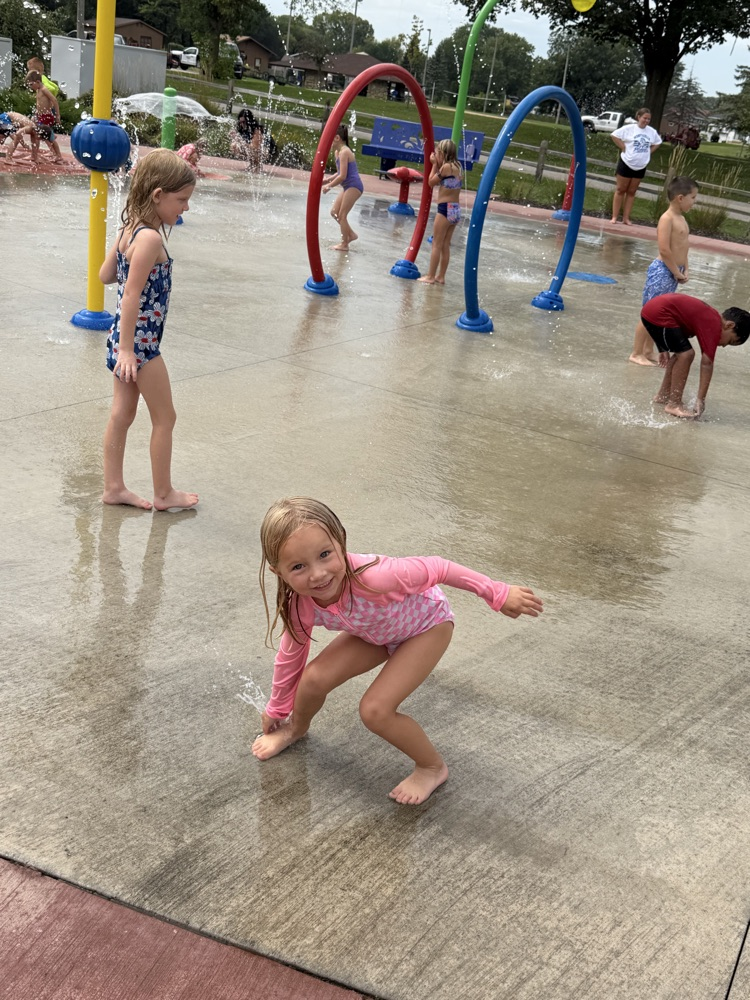student playing at splash pad