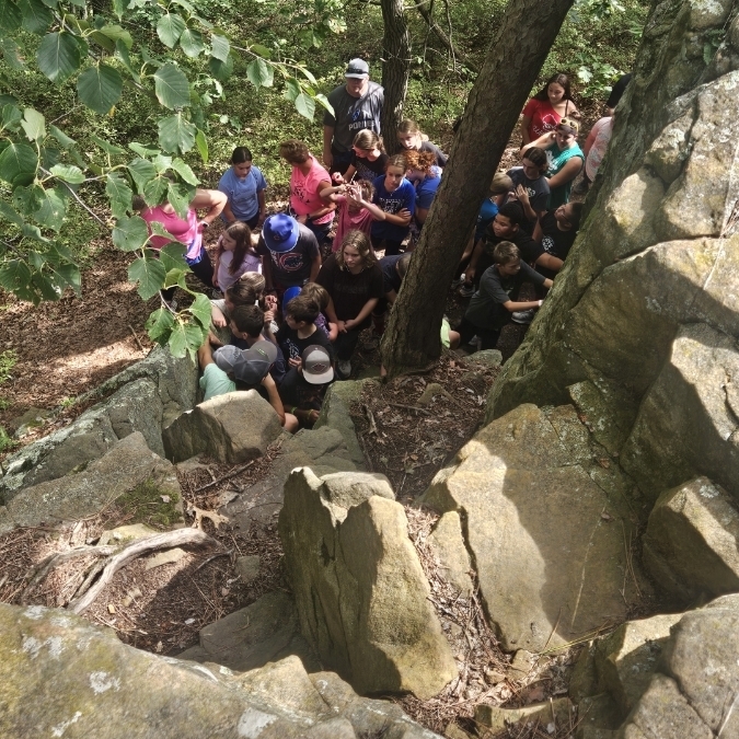 students and staff on a hike