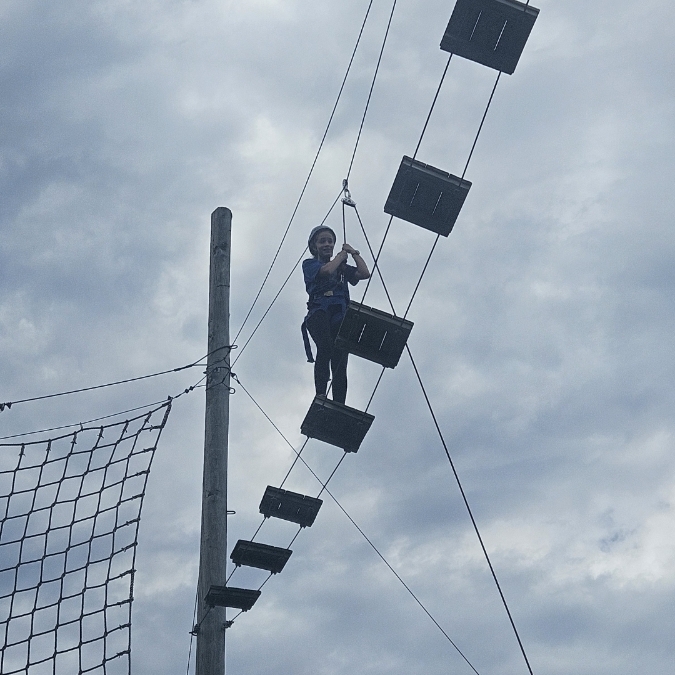 student on high ropes course