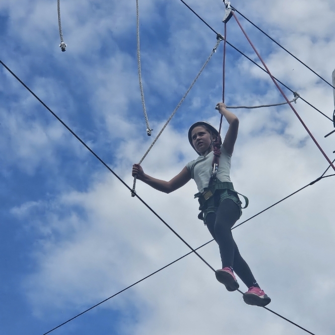 student on high ropes course