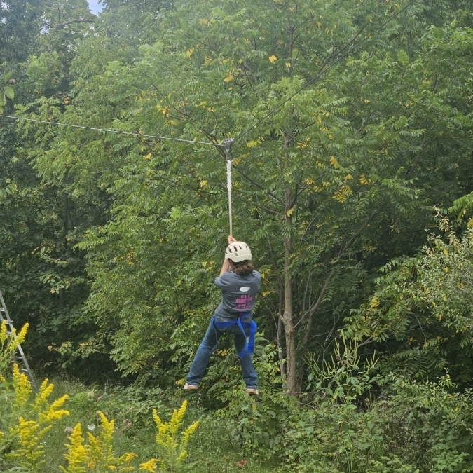 student on high ropes course