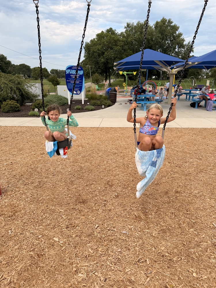 Two students on baby swings