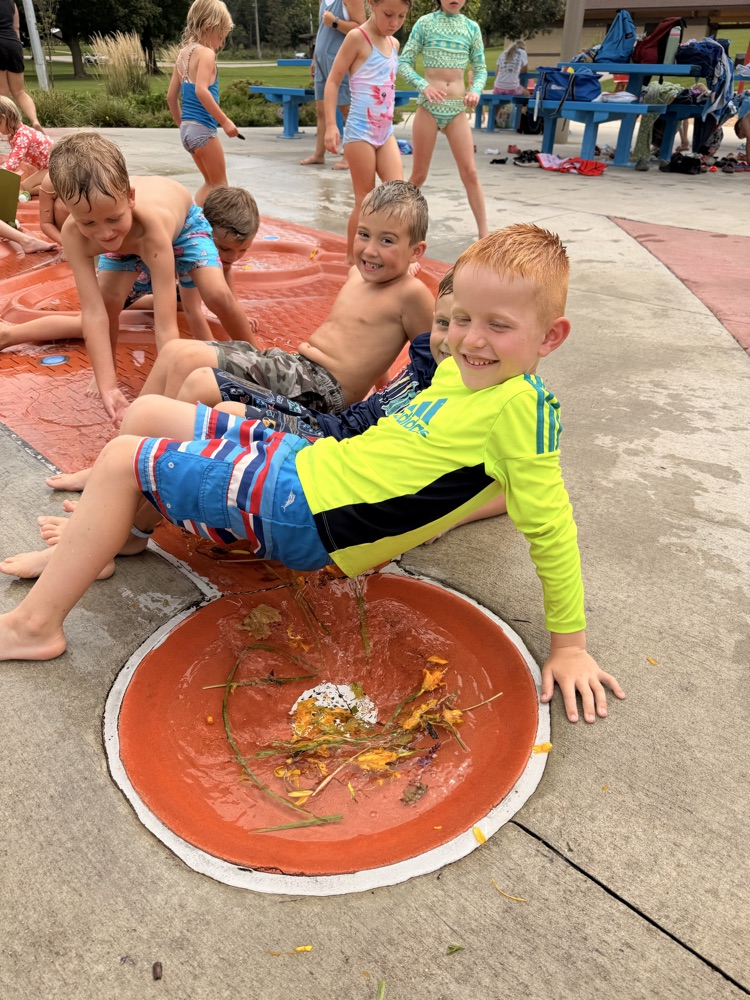 students making a bridge at a splash pad