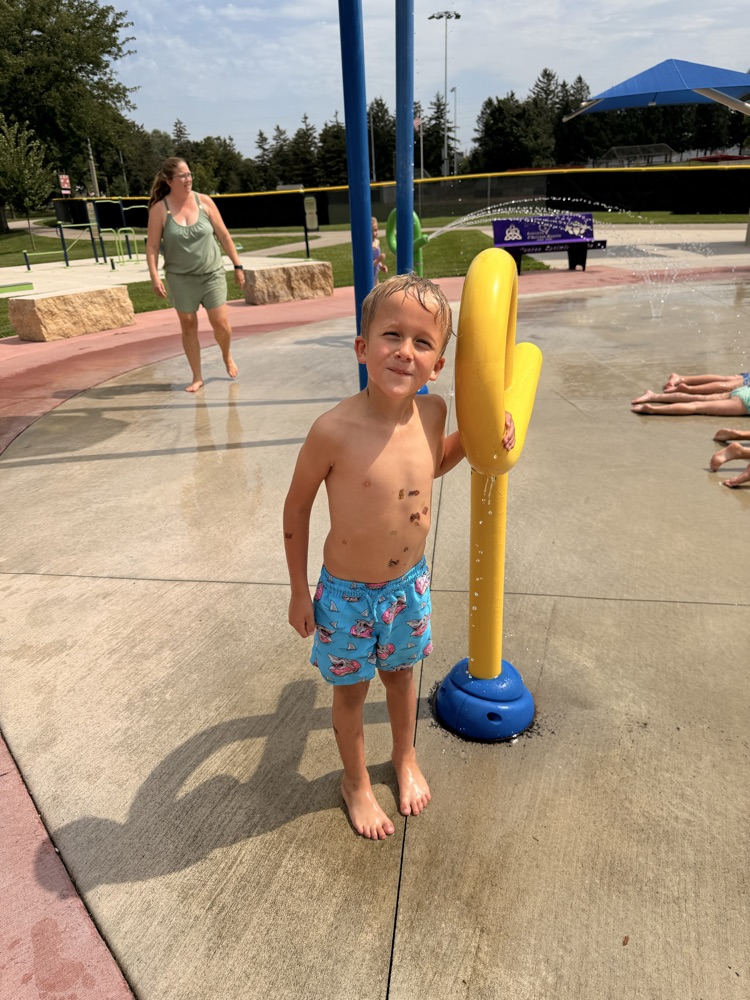 student smiling at splash pad
