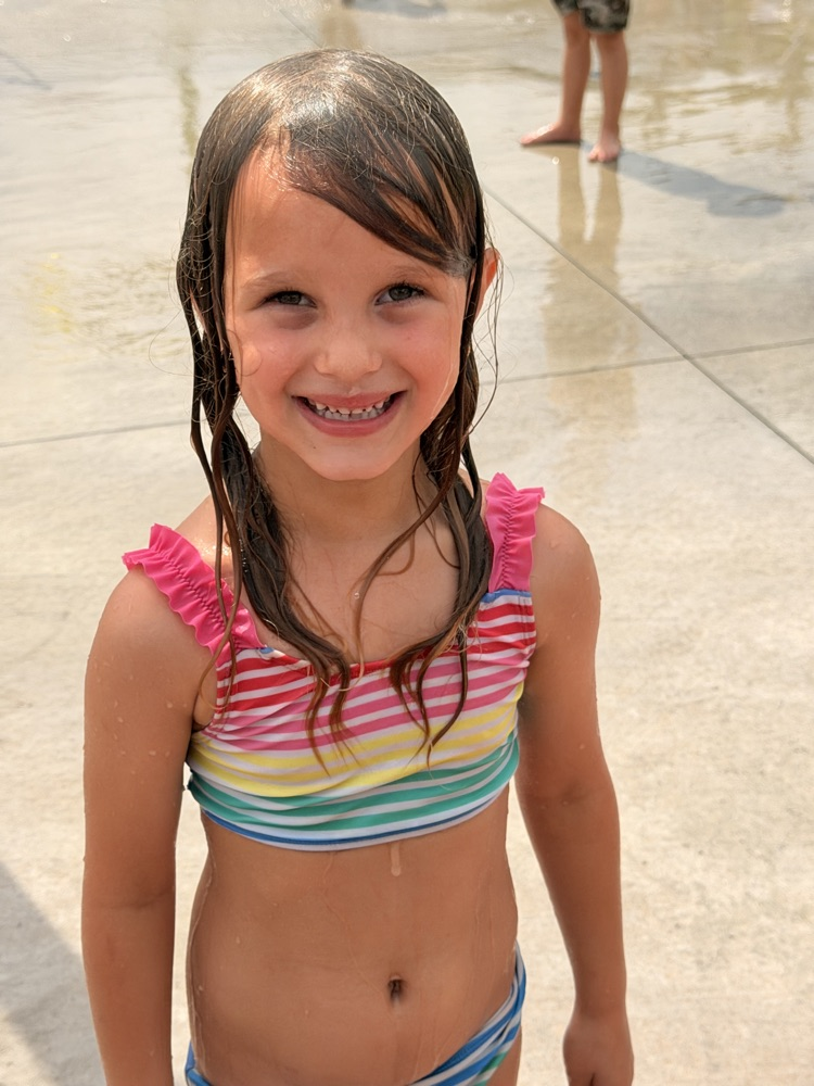 smiling student at splash pad
