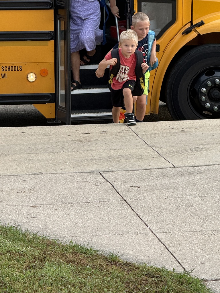 students getting off the bus