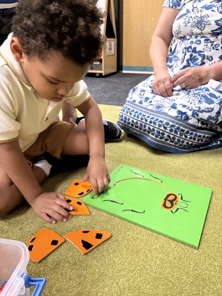 Child putting together a puzzle