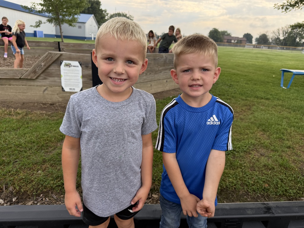 two student smiling on the playground