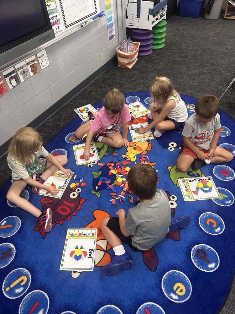 kindergartners on the floor playing math games