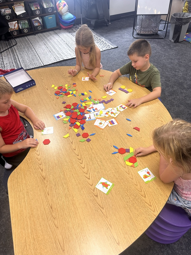 kindergartners playing a math game at a table