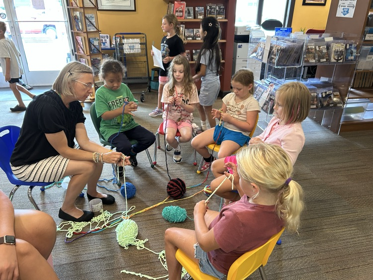 2nd graders learning to “finger knit” with the Monticello Public librarian