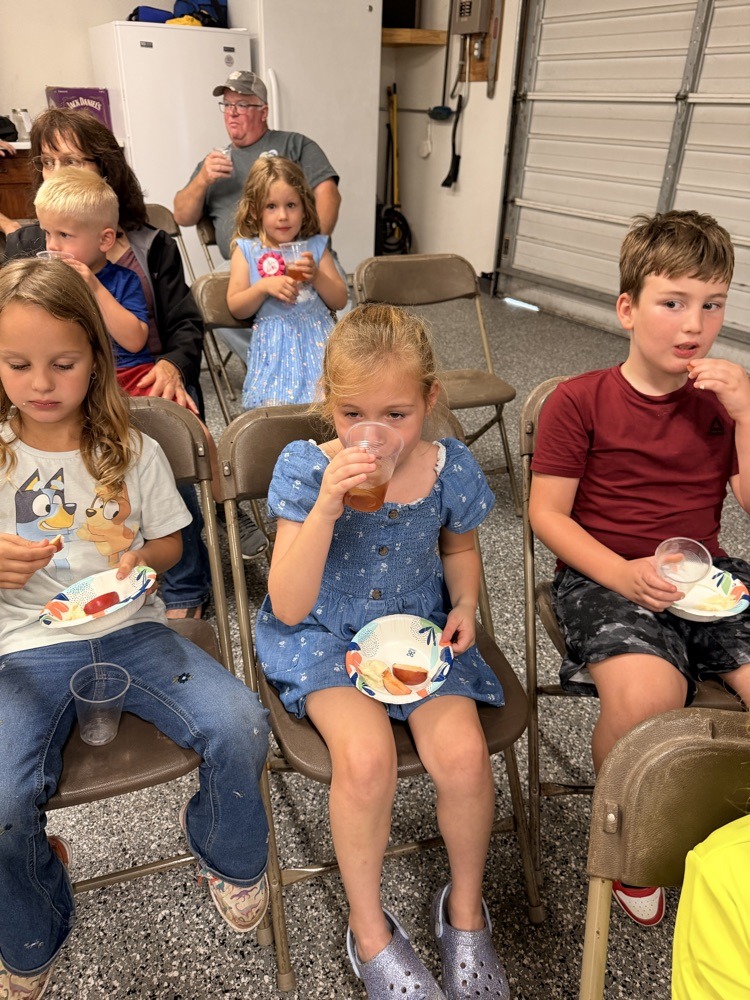 students eating apples and drinking apple cider