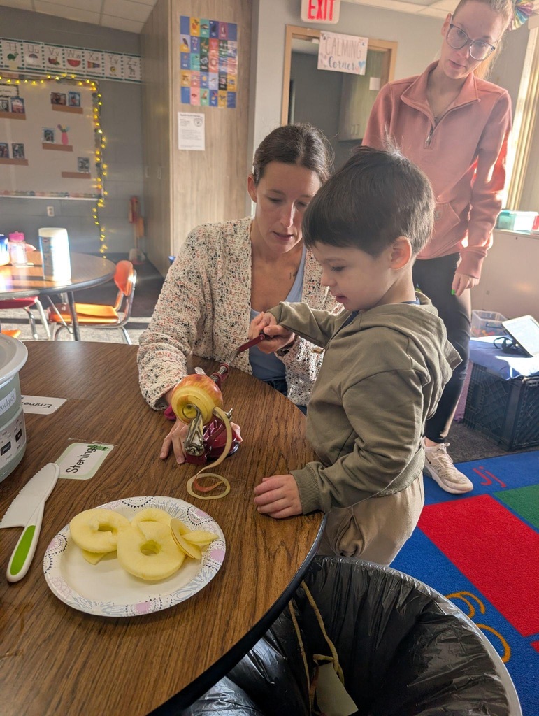 student helping teacher peel an apple