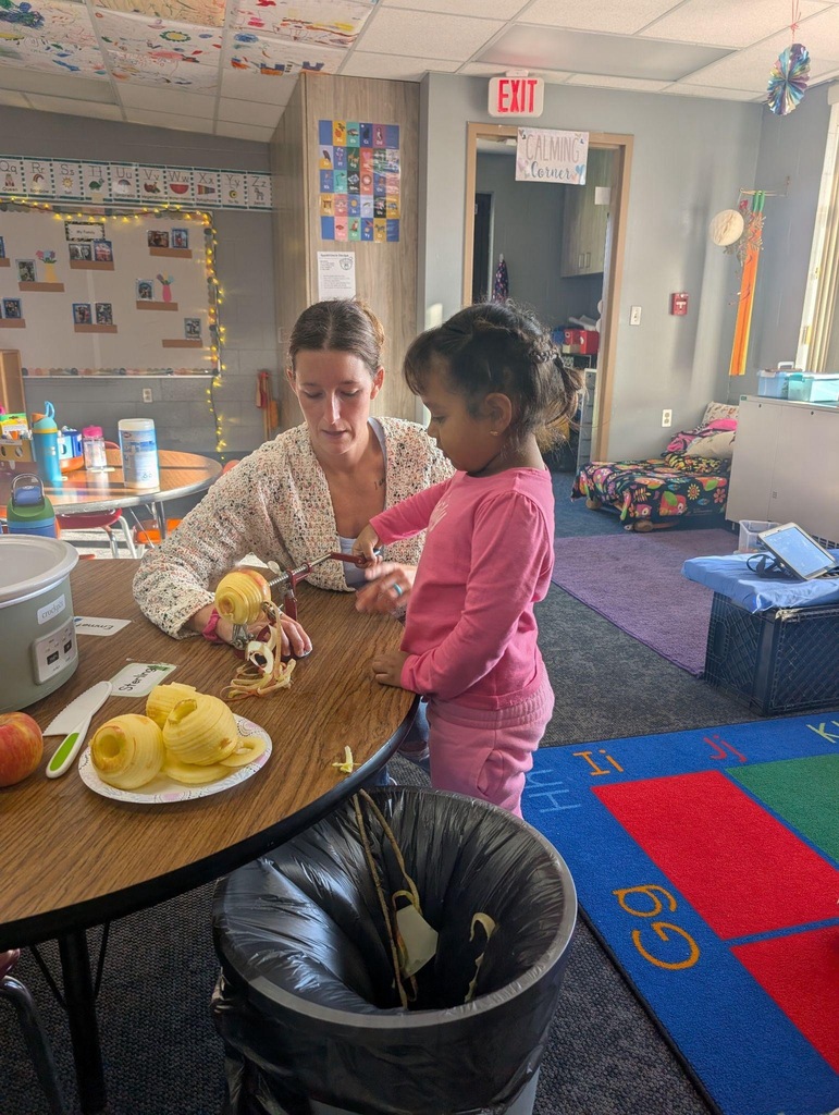 student helping teacher peel an apple