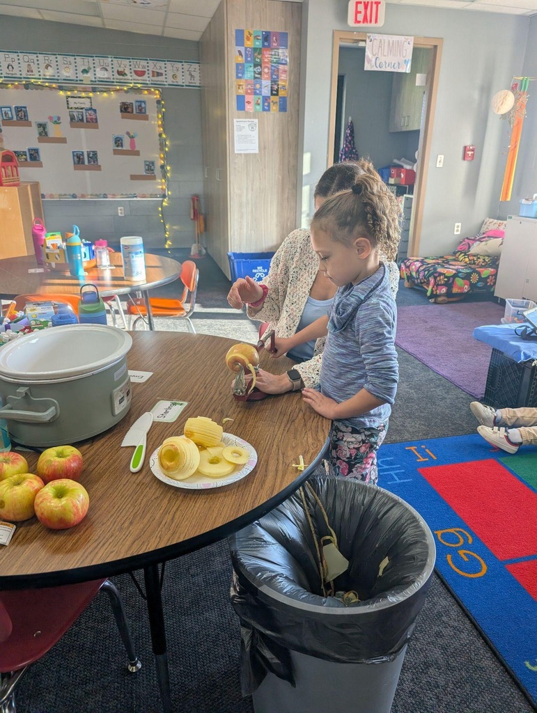 student helping teacher peel an apple