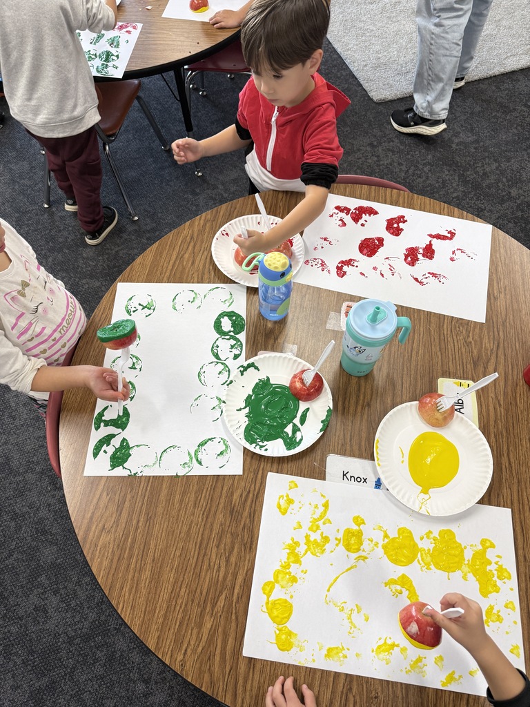 student painting with an apple